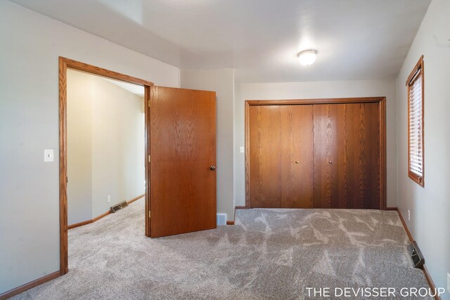2766 48th Ave, Zeeland, MI 49464 - unfurnished bedroom featuring carpet floors, a closet, and baseboards