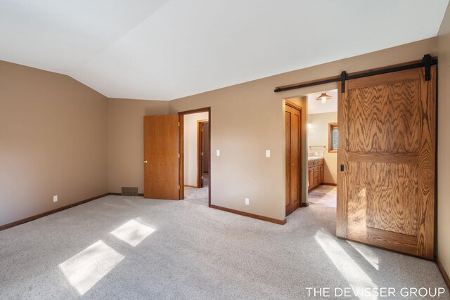 2766 48th Ave, Zeeland, MI 49464 - unfurnished bedroom featuring lofted ceiling, light colored carpet, baseboards, and connected bathroom