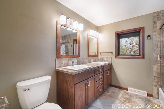 2766 48th Ave, Zeeland, MI 49464 - bathroom featuring double vanity, toilet, decorative backsplash, and baseboards