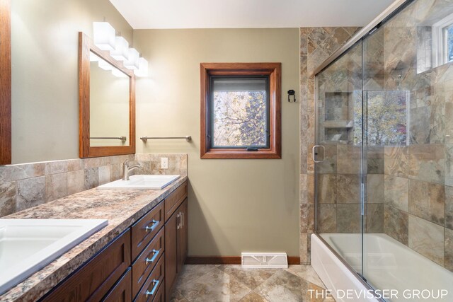 2766 48th Ave, Zeeland, MI 49464 - bathroom with baseboards, double vanity, combined bath / shower with glass door, and healthy amount of natural light