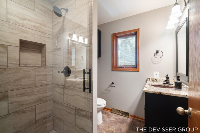2766 48th Ave, Zeeland, MI 49464 - bathroom with vanity, a shower stall, toilet, and baseboards