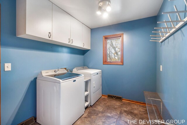 2766 48th Ave, Zeeland, MI 49464 - laundry area with washer and dryer, cabinet space, baseboards, and stone finish floors