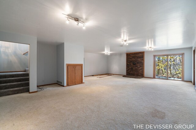 2766 48th Ave, Zeeland, MI 49464 - below grade area featuring light colored carpet, stairway, and baseboards