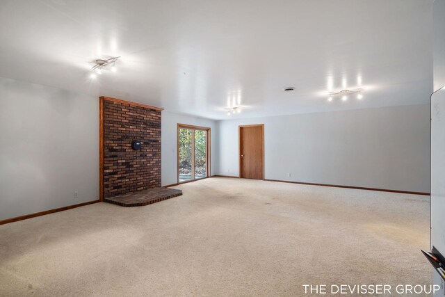 2766 48th Ave, Zeeland, MI 49464 - unfurnished living room with carpet, baseboards, and a fireplace