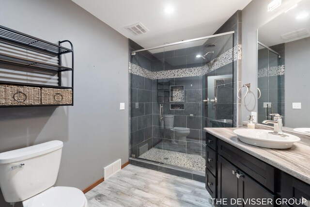 2766 48th Ave, Zeeland, MI 49464 - full bathroom with toilet, wood finished floors, vanity, and a shower stall