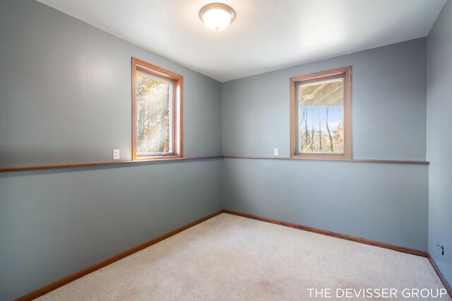 2766 48th Ave, Zeeland, MI 49464 - spare room featuring plenty of natural light, carpet flooring, and baseboards