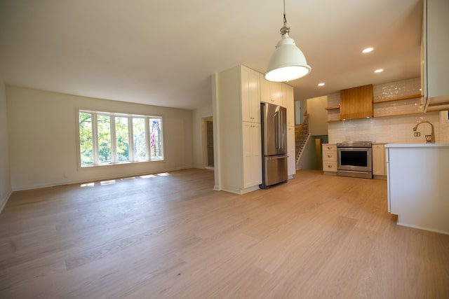 interior space with light wood-type flooring, a sink, recessed lighting, stairway, and baseboards