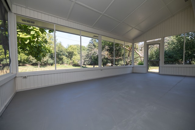 unfurnished sunroom featuring vaulted ceiling