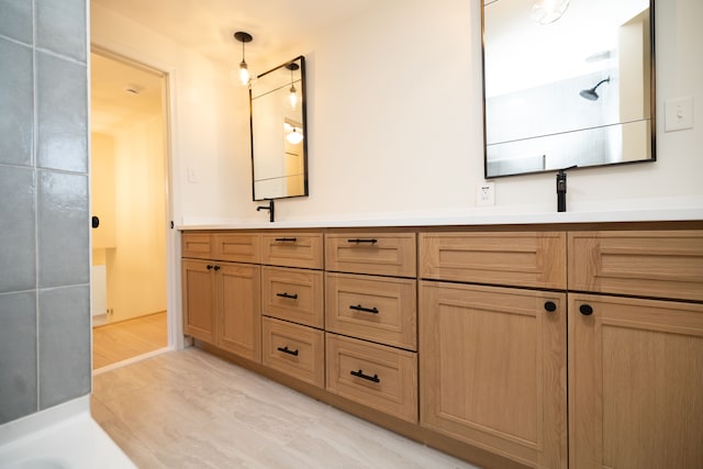 full bathroom featuring double vanity and a sink