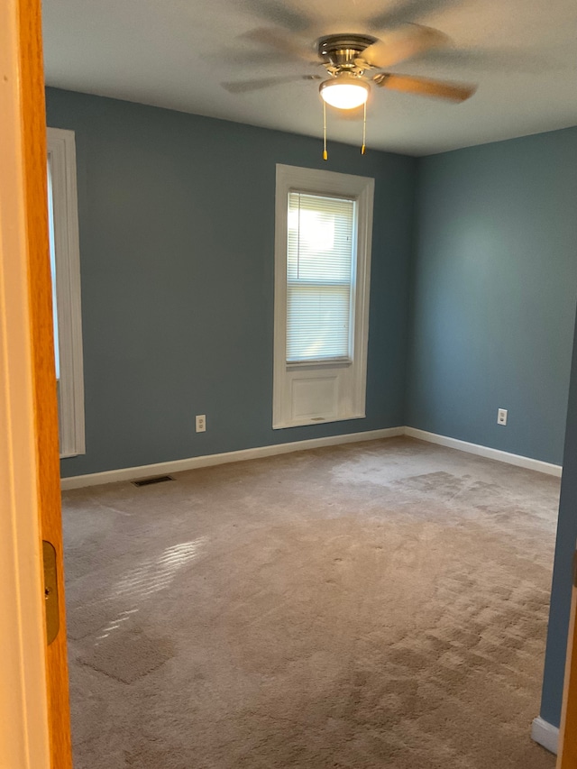 carpeted empty room with ceiling fan