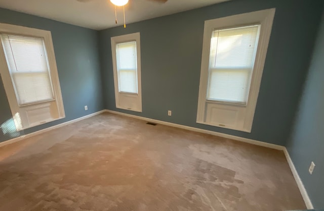 carpeted empty room with ceiling fan