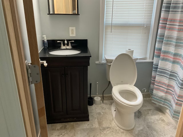 bathroom with vanity, toilet, and walk in shower