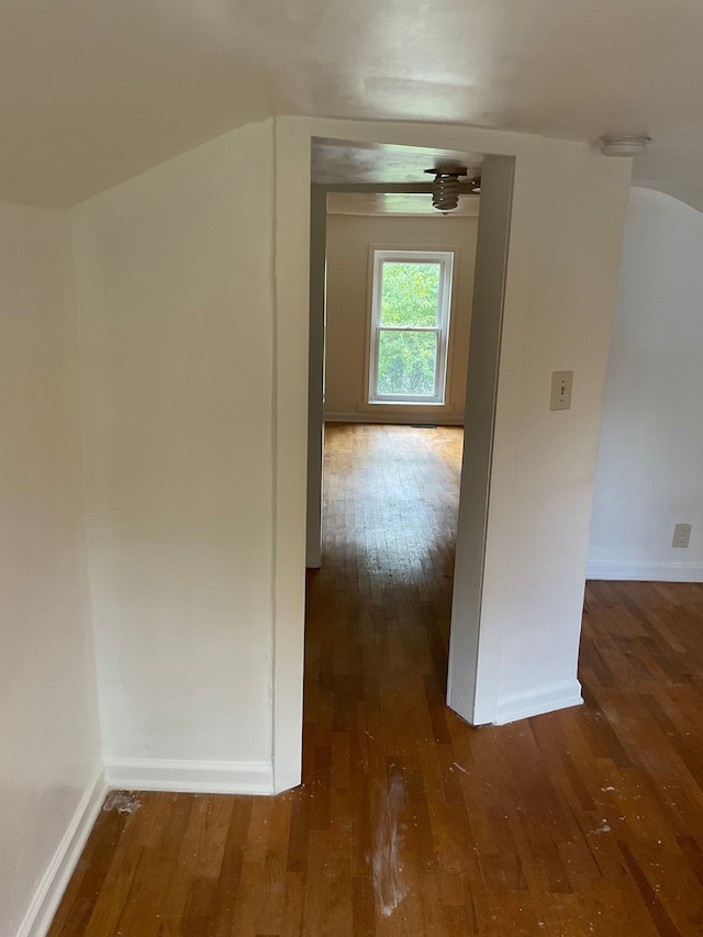 additional living space featuring dark hardwood / wood-style floors and vaulted ceiling