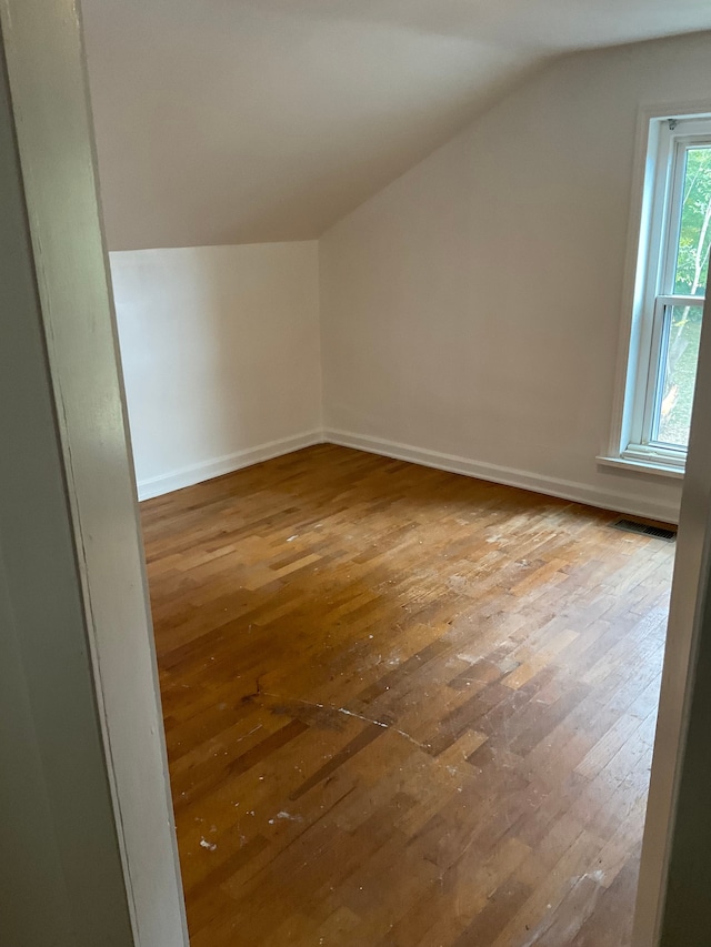 bonus room featuring lofted ceiling and hardwood / wood-style flooring