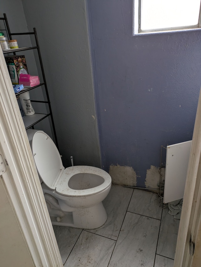 bathroom with toilet and tile patterned floors