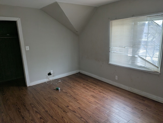 bonus room with a wealth of natural light, dark hardwood / wood-style floors, and lofted ceiling