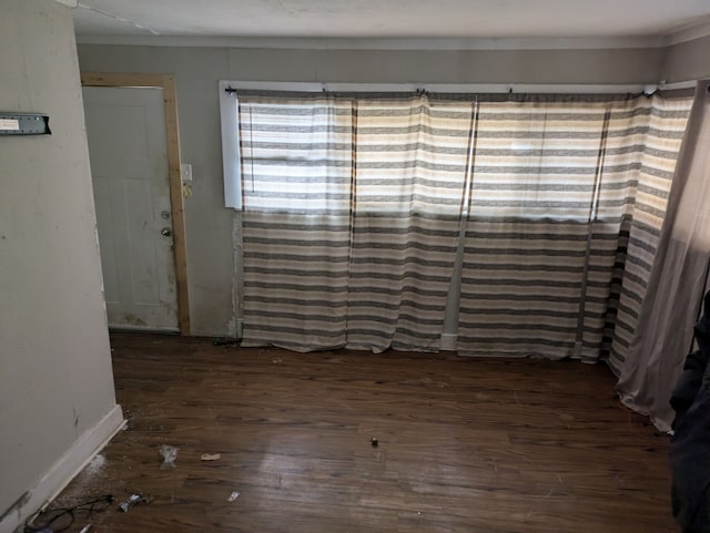 unfurnished dining area featuring dark wood-type flooring