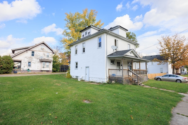 view of front facade featuring a trampoline, a porch, and a front yard