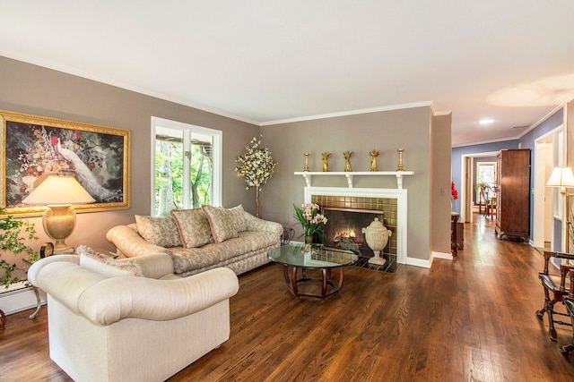 living room with ornamental molding, dark wood-type flooring, and a tile fireplace