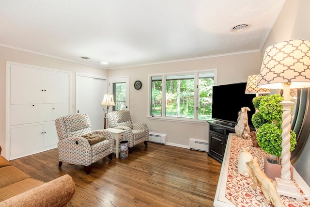 living room featuring ornamental molding, baseboard heating, and dark wood-type flooring