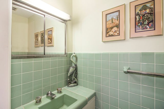 bathroom with tile walls and sink