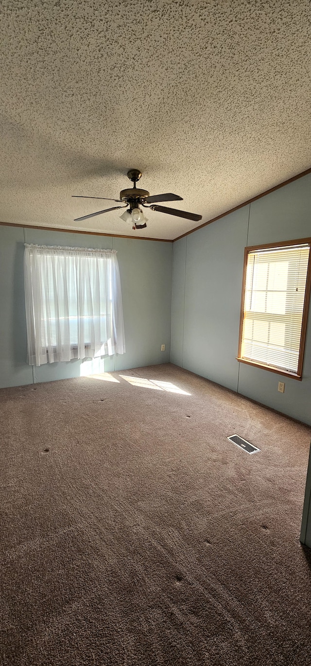 unfurnished room featuring a textured ceiling, carpet floors, and ceiling fan