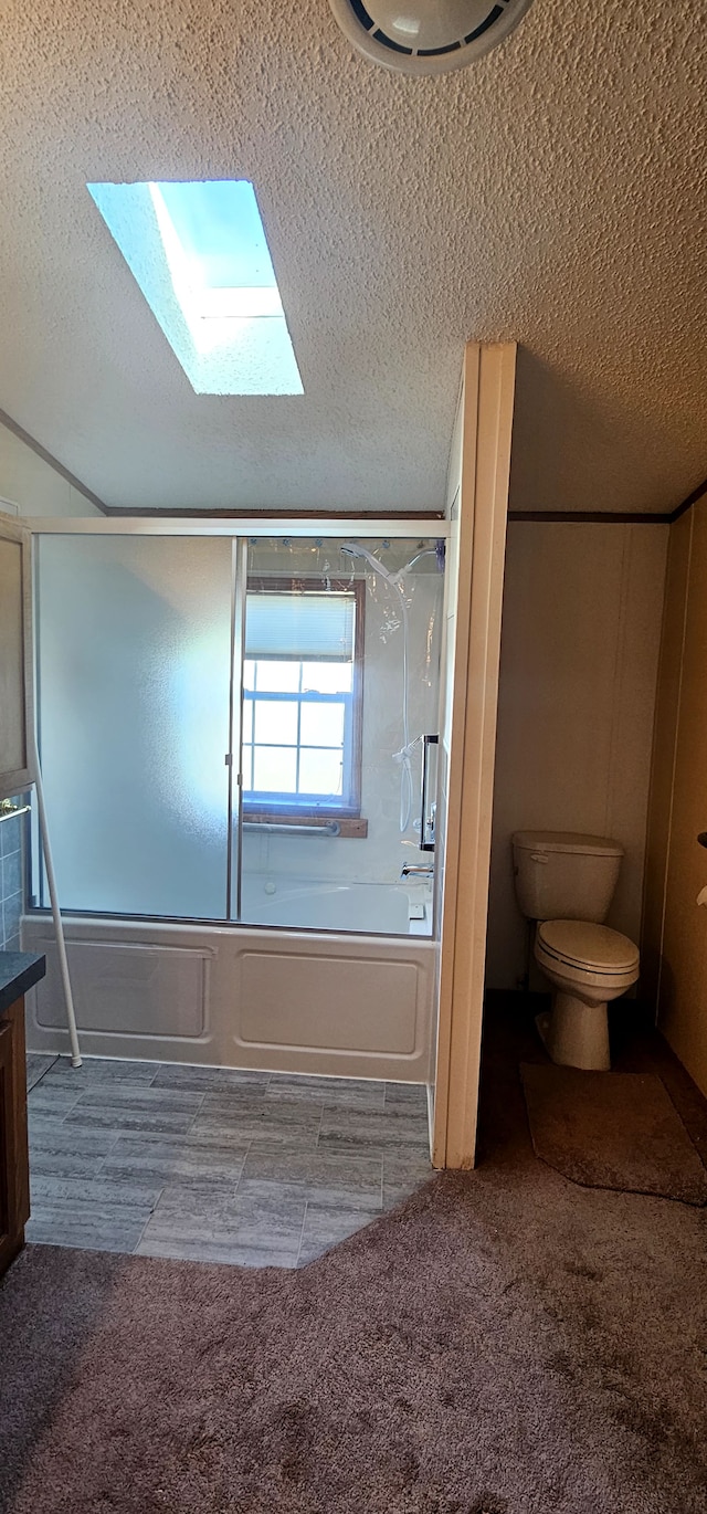 full bathroom featuring vanity, toilet, enclosed tub / shower combo, and a textured ceiling