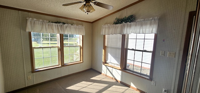 spare room featuring vaulted ceiling, crown molding, ceiling fan, and a textured ceiling