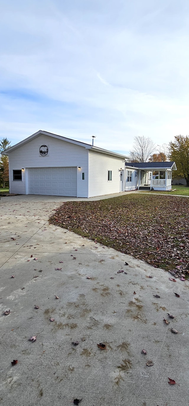 exterior space with covered porch and a garage