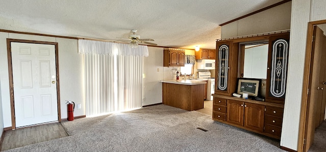 bathroom featuring vanity, a textured ceiling, ceiling fan, crown molding, and lofted ceiling