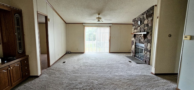 hall with a textured ceiling, carpet floors, and crown molding