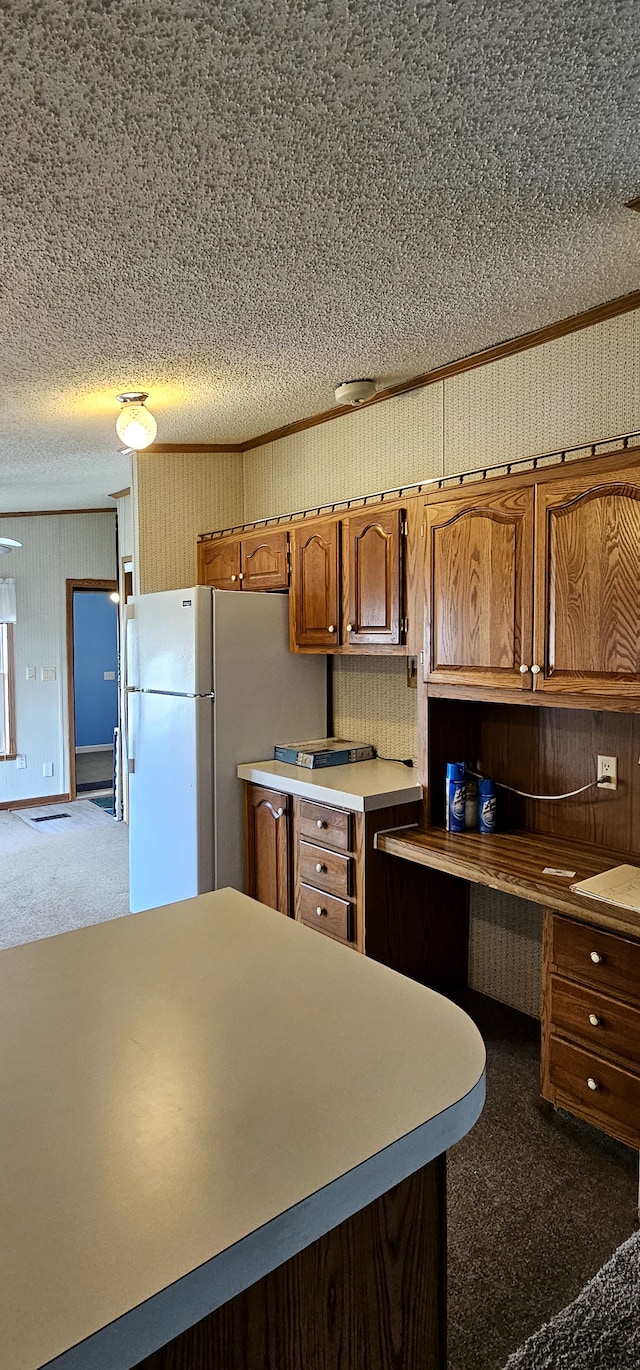 kitchen with backsplash, dark carpet, a textured ceiling, and white refrigerator