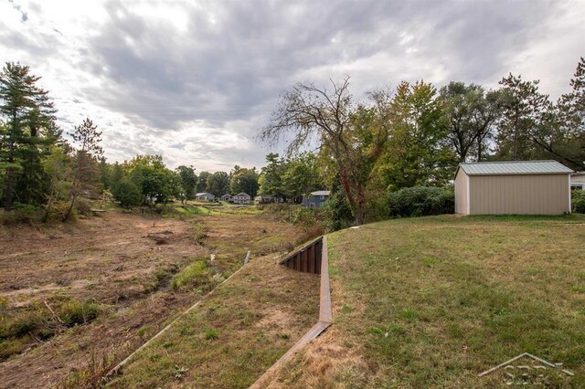 4029 Cobblestone Ct, Beaverton, MI 48612 - view of green lawn featuring an outbuilding