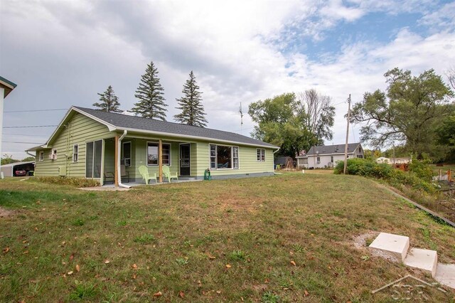 4029 Cobblestone Ct, Beaverton, MI 48612 - view of front of house with a front lawn and a porch