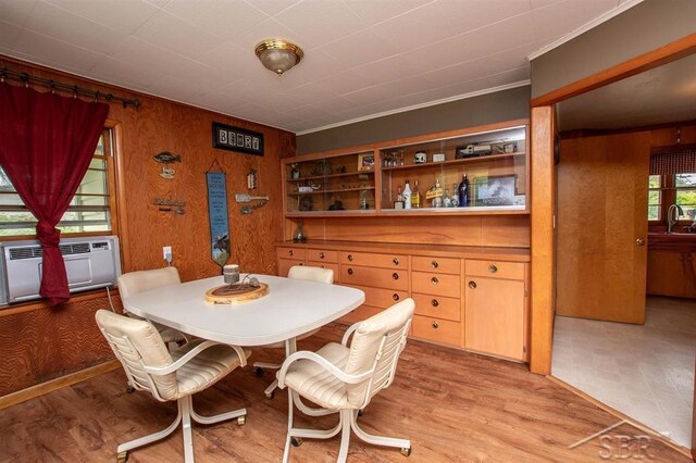 4029 Cobblestone Ct, Beaverton, MI 48612 - dining room with light wood-type flooring, a wall mounted AC, and wood walls
