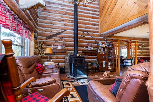 living room with beam ceiling, a high ceiling, wooden ceiling, and a wood stove