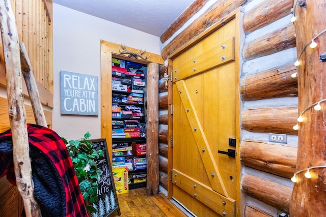 interior space featuring log walls and hardwood / wood-style floors