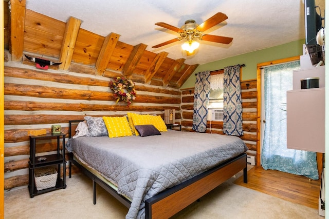 bedroom with log walls, light hardwood / wood-style floors, ceiling fan, and cooling unit