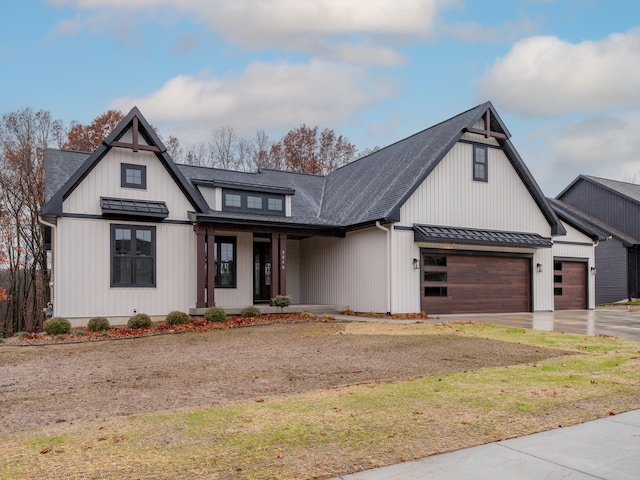 modern inspired farmhouse with a porch and a garage