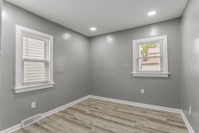 spare room featuring light wood-type flooring