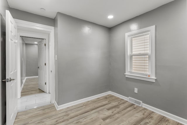 empty room with light hardwood / wood-style floors