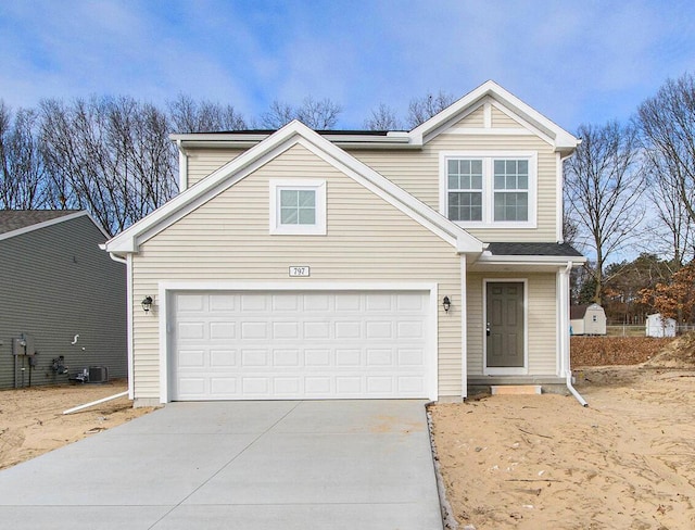 traditional-style house with a garage and driveway