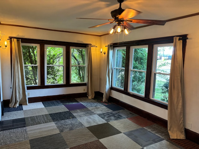 unfurnished room featuring ceiling fan, plenty of natural light, and crown molding