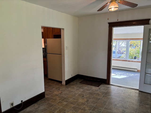 spare room featuring ceiling fan and a baseboard heating unit