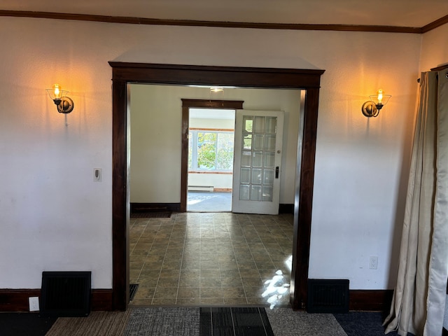 hall with baseboard heating, crown molding, and french doors