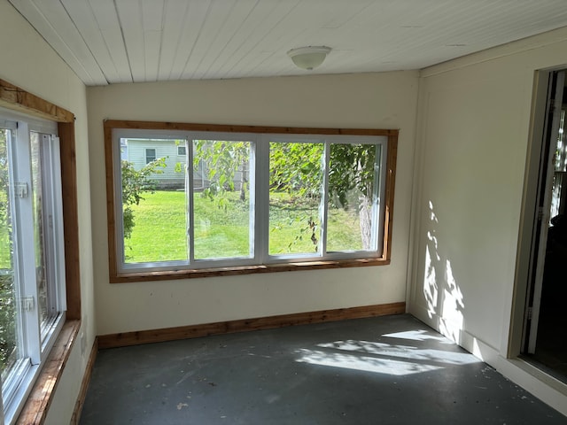 unfurnished sunroom featuring plenty of natural light and vaulted ceiling