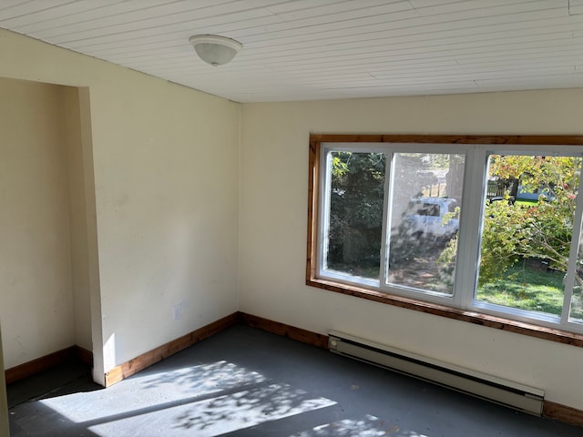 unfurnished room with baseboard heating and a healthy amount of sunlight