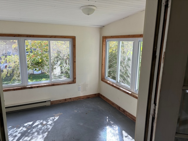 spare room featuring plenty of natural light, lofted ceiling, and baseboard heating