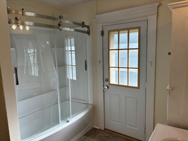 bathroom with shower / bath combination with glass door