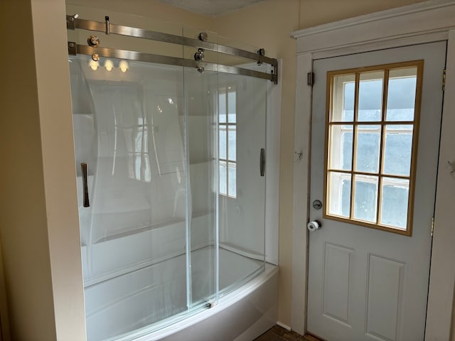 bathroom featuring shower / bath combination with glass door